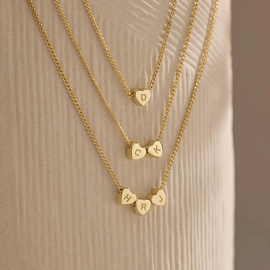 Three necklaces with different lengths and numbers of hearts.